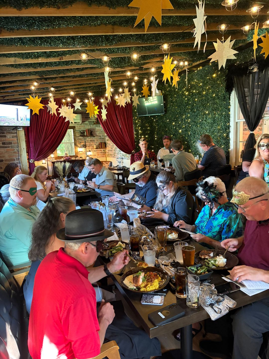 Masked guests dining and playing detective at a Murder Mystery dinner in Smithfield, Virginia