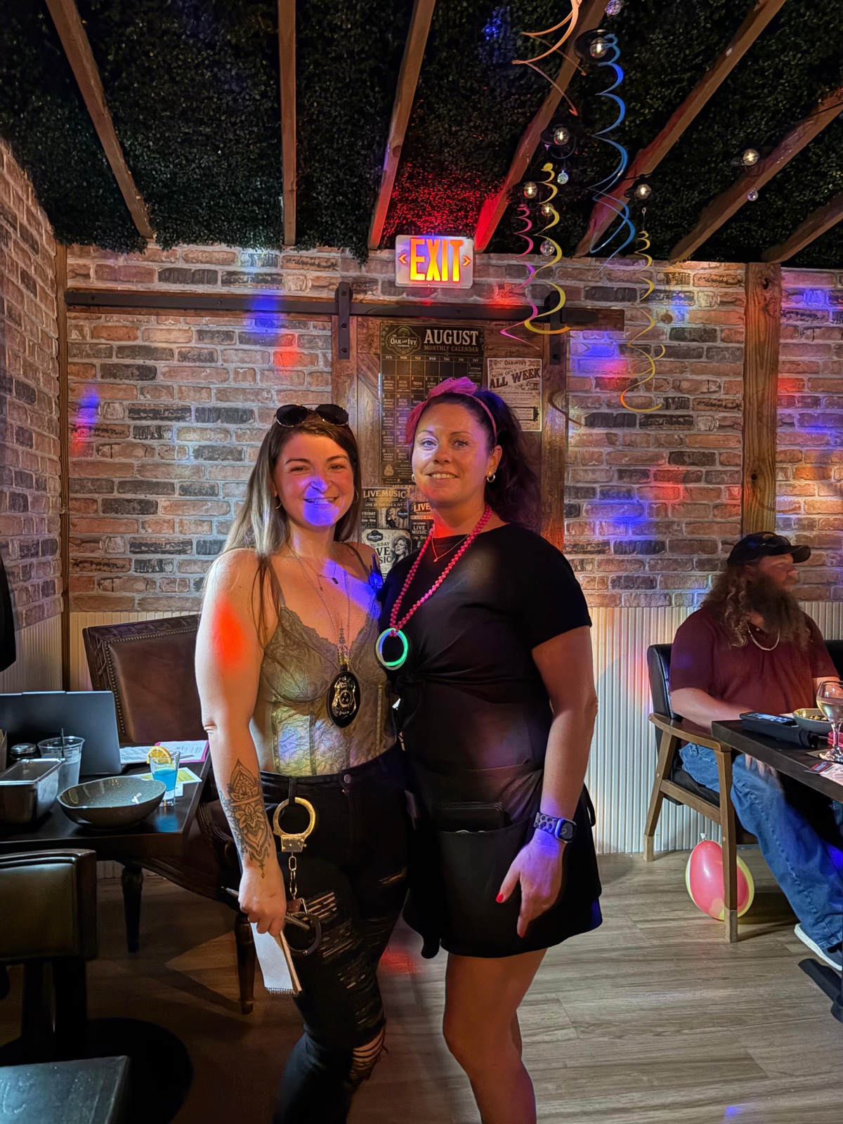 Two guests in costume with detective badges at a Murder Mystery Dinner