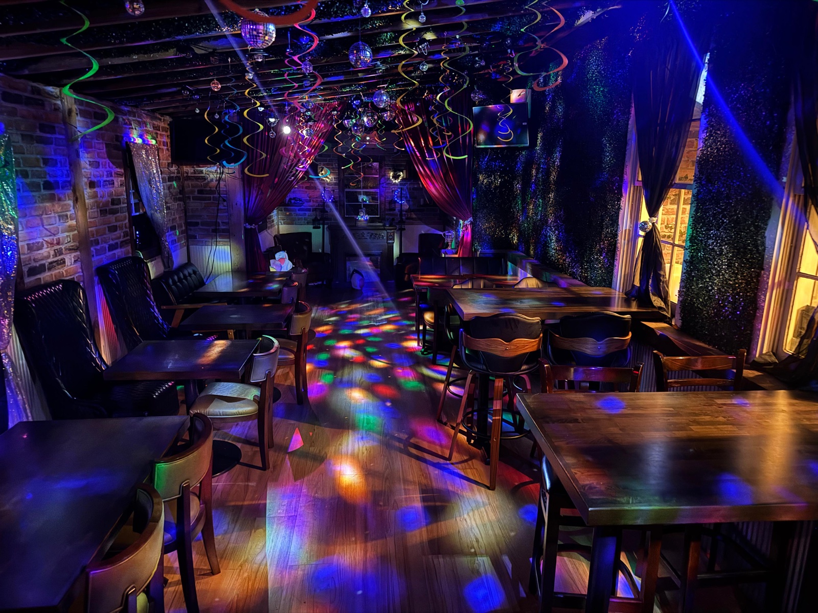The ivy room decked out for a Murder Mystery Dinner with disco balls and colorful lights