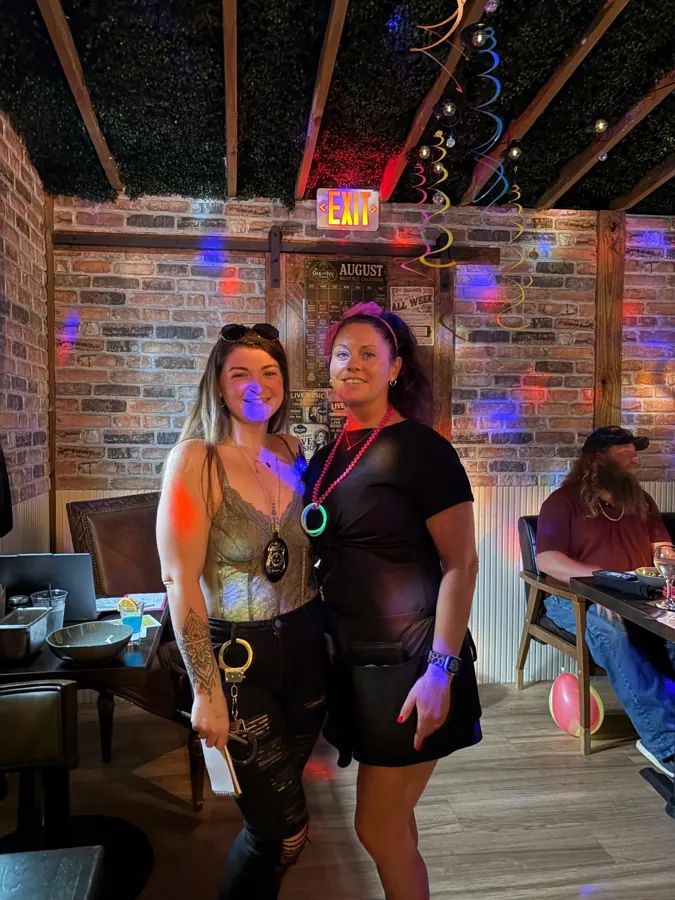 Two guests in costume with detective badges at a Murder Mystery Dinner