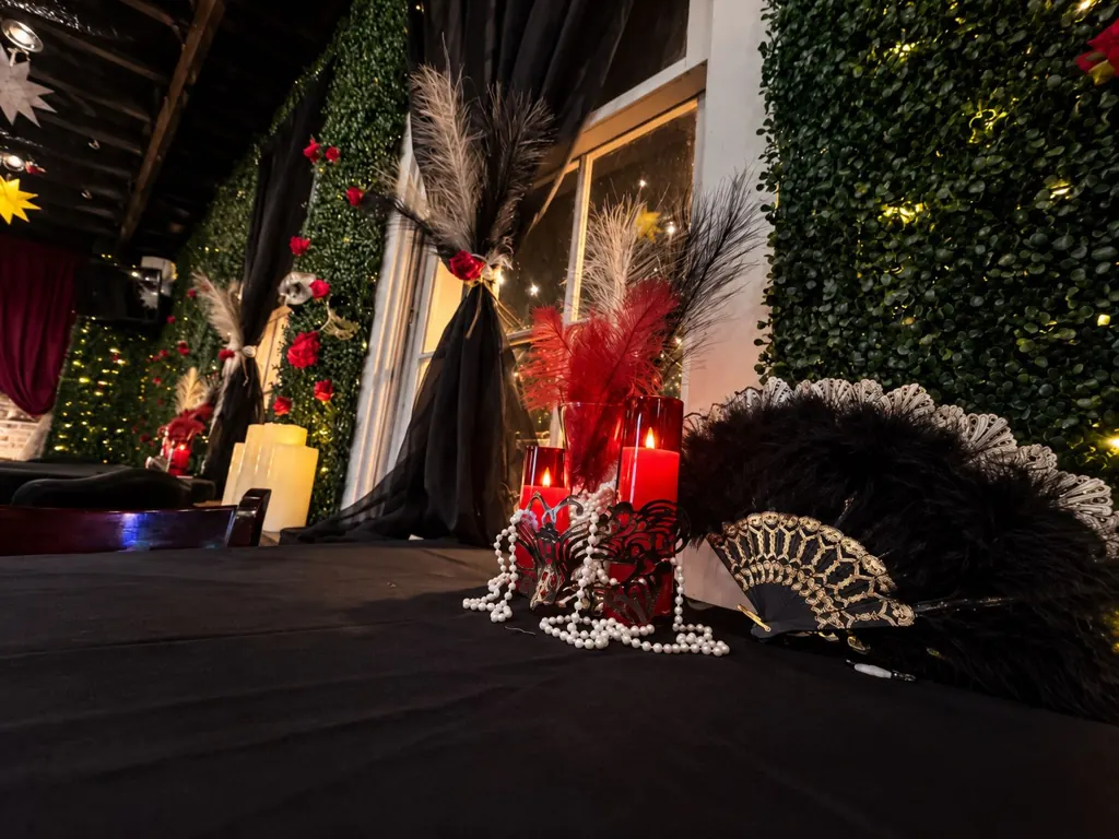 Masquerade masks and candlelit feather centerpiece at The Oak & Ivy Taphouse