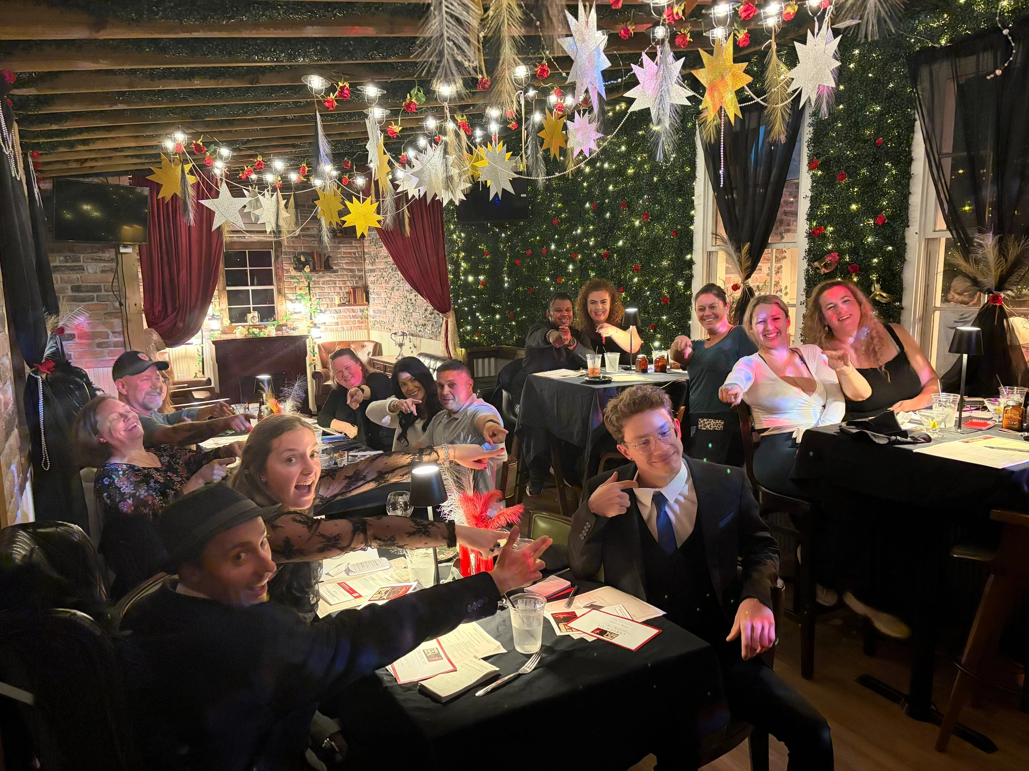 Guests pointing and laughing after figuring out who did it at a Murder Mystery Dinner