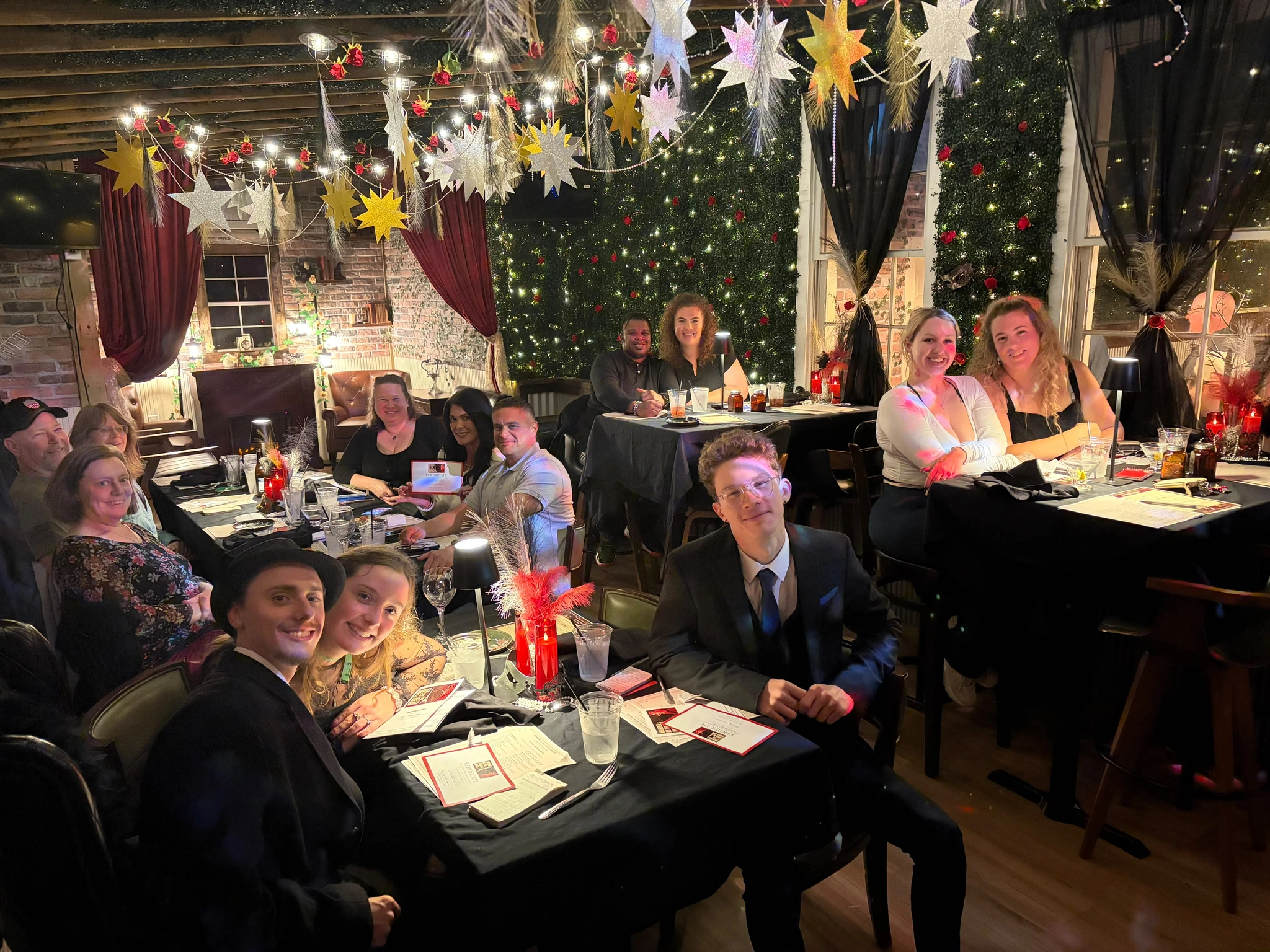 Guests smiling together before figuring out who did it at a Murder Mystery Dinner